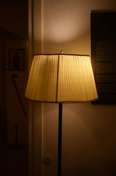 A lamp glowing in a dark room